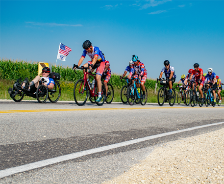 A group of cyclists riding on a road.